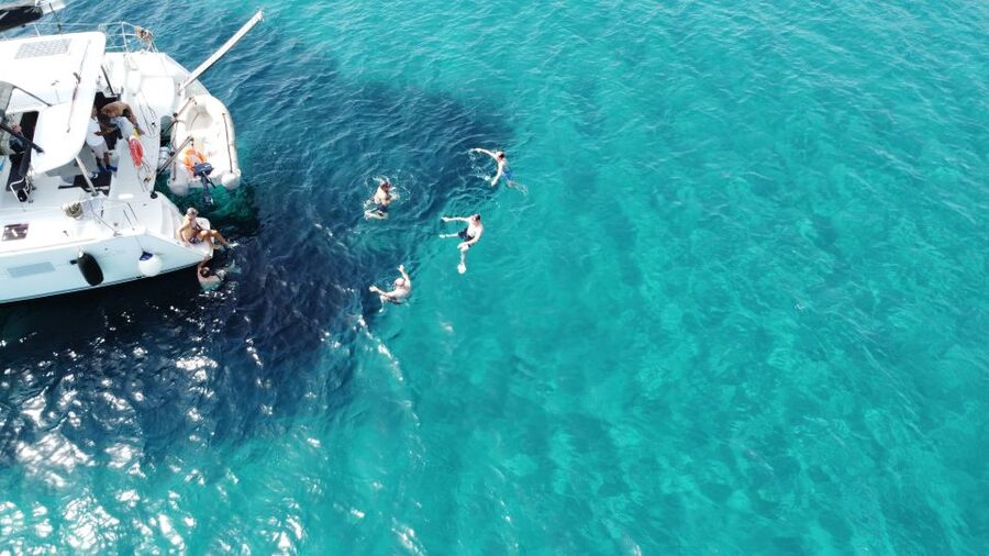Athens: Catamaran Cruise with Fresh Lunch and Wine - Hydroussa islet: your first swim from the boat