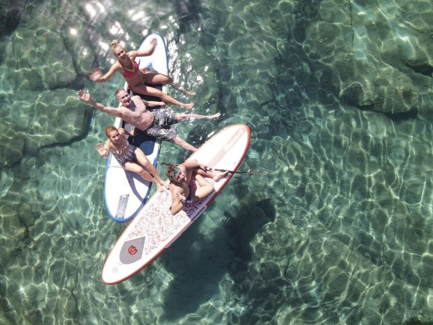 From Ornos: Mykonos Delos Catamaran Cruise with Meal & SUP - A Greek lunch served on deck