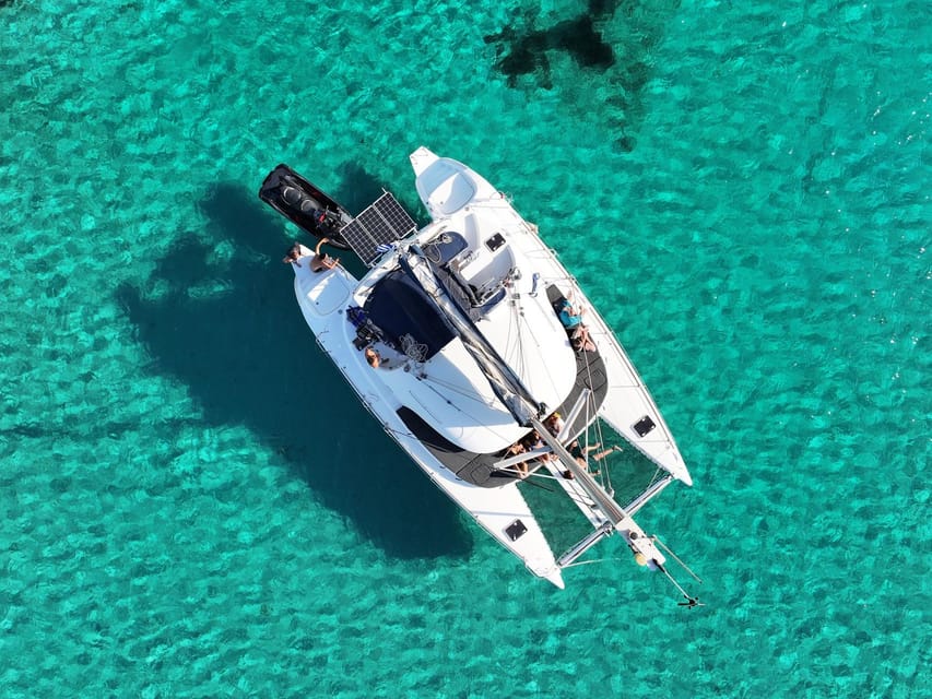 From Ornos: Mykonos Delos Catamaran Cruise with Meal & SUP - Sailing back with Mykonos in view