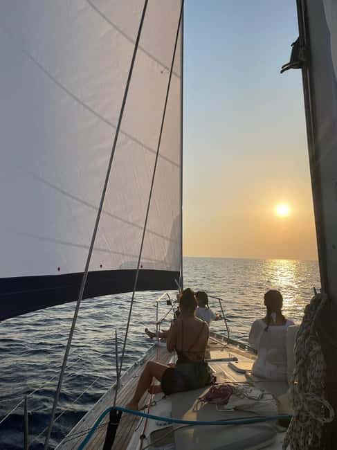 Mykonos: Sunset Sail Cruise to Rhenia, Beach Hopping, Dinner - Dinner, drinks, and the sunset return