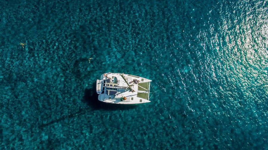 Santorini: 7-Hour Private Catamaran Cruise with Food & Drink - Oia from the water, with lunch onboard