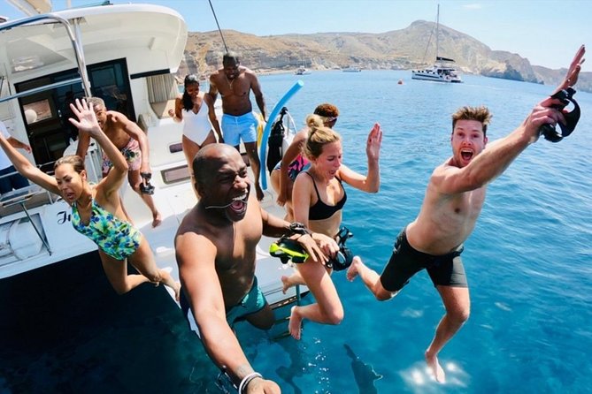 Santorini All-inclusive Catamaran Cruise with Thirassia Stop - Black Mountain, lighthouse, and White Beach