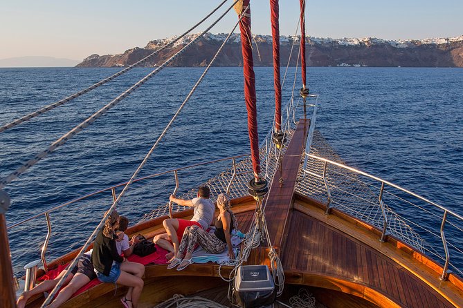 Santorini Caldera Sunset Sailing Cruise with Dinner and Wine - Sunset near Oia, seen from the caldera