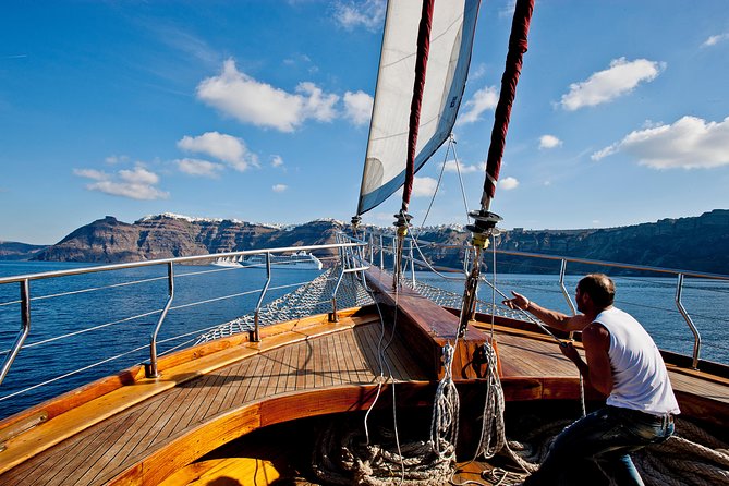 Santorini Caldera Sunset Sailing Cruise with Dinner and Wine - Boat atmosphere, seating, and entertainment