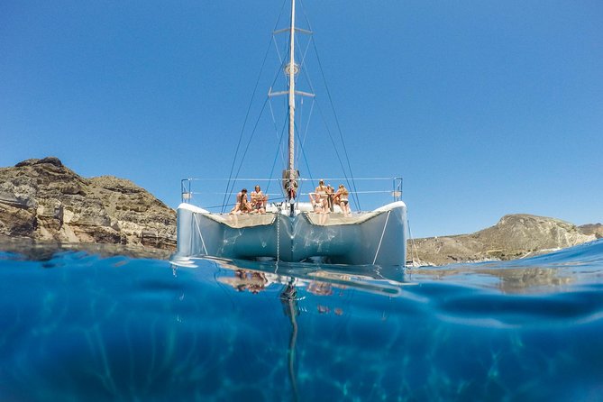 Santorini Catamaran Cruise with Fresh Meal and Open Bar - Red Beach: Santorini’s rust-colored coast