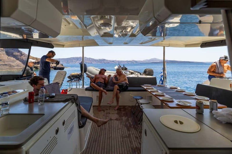 Santorini: Catamaran Cruise with Fresh Meal & Open Bar - Swimming at Black Mountain’s coves