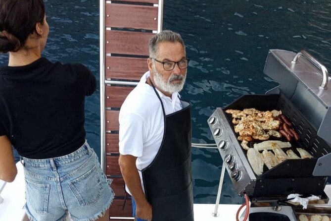 Santorini Catamaran Cruise with Meal and Drinks - Indian Rock, sea caves, and the old lighthouse