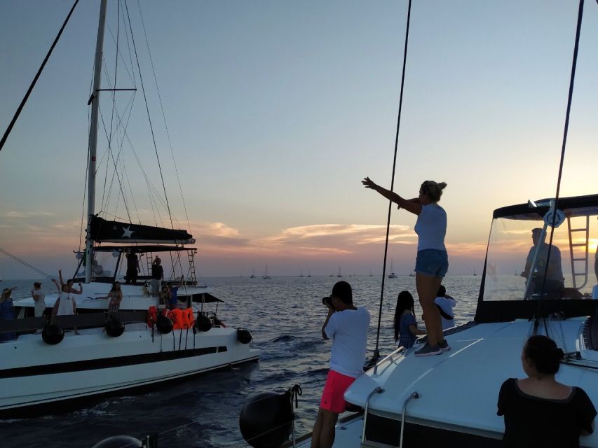 Santorini: Catamaran Cruise with Meal & Open Bar - The Akrotiri lighthouse and volcanic coast