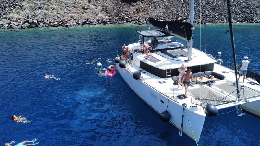 Santorini Catamaran Cruise with Swimming, Meal and Open Bar - Red Beach and the southern coast