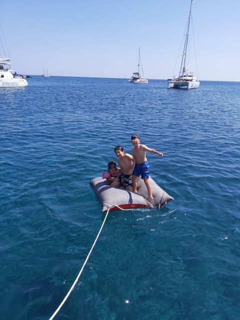 Santorini:Catamaran: private cruise with food & drinks - Black Mountain, Indian Rock, and the Lighthouse