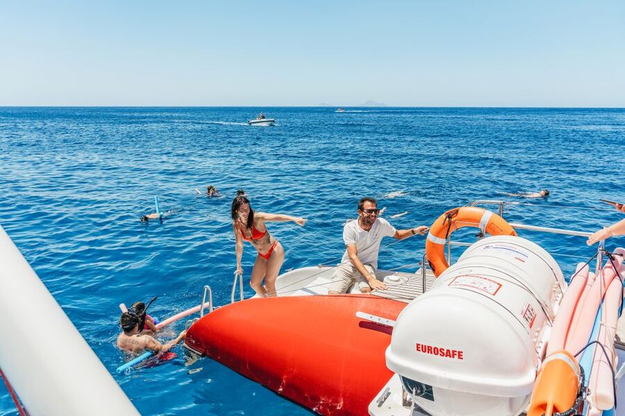 Santorini: Catamaran Tour with BBQ Dinner, Drinks, and Music - Red Beach Gives You the Best Swimming Break