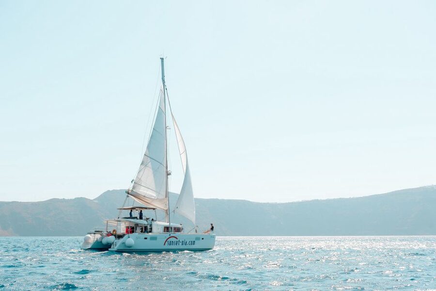 Santorini: Catamaran Tour with BBQ Meal and Unlimited Drinks - Red Beach and the best swimming stop
