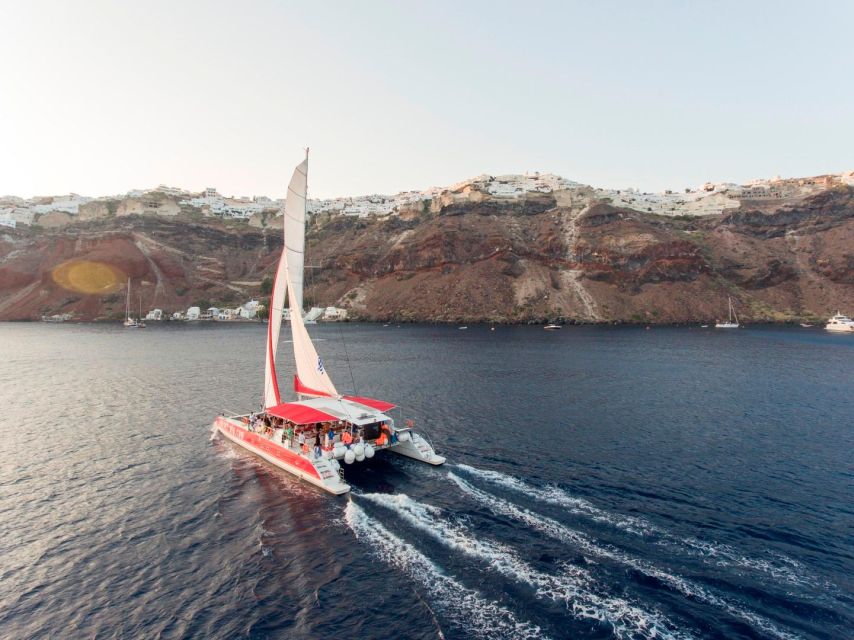 Santorini: Cruise Catamaran with BBQ & Drinks Day or Sunset - Crew service and the mood onboard