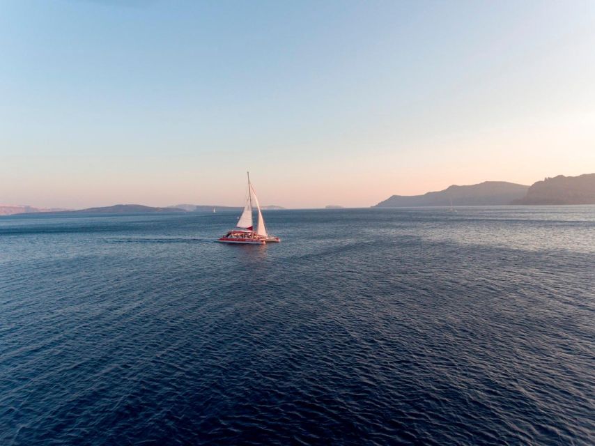Santorini: Cruise Catamaran with BBQ & Drinks Day or Sunset - Leaving Thera and heading toward the caldera