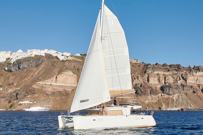 Santorini Gold Catamaran Cruise with BBQ, Drinks and Hotel Pickup - The volcano and hot springs stop