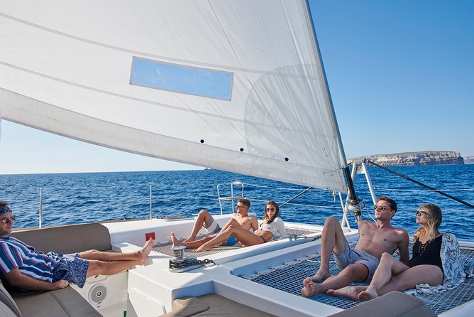 Santorini Gold Catamaran Cruise with BBQ, Drinks and Hotel Pickup - What the crew adds to the experience