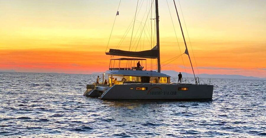Santorini: Luxurious Catamaran Cruise with Meal & Open Bar - Welcome cocktail and the caldera cliffs