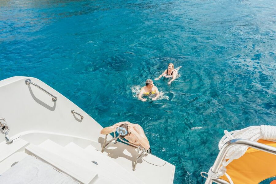 Santorini: Luxury Catamaran Day Trip with Meal and Open Bar - Daytime sailing or sunset beneath Oia