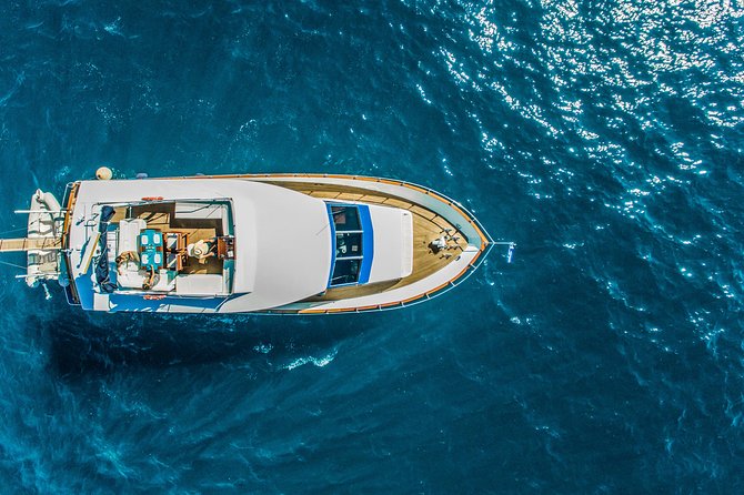 Santorini: Motor Yacht Sunset Cruise with 5-Course Dinner - Swimming near the volcano and Mesa Pigadia