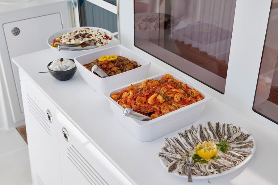 Santorini: Platinum Catamaran Cruise w/ BBQ Meal & Open Bar - Red Beach and the first coastal views