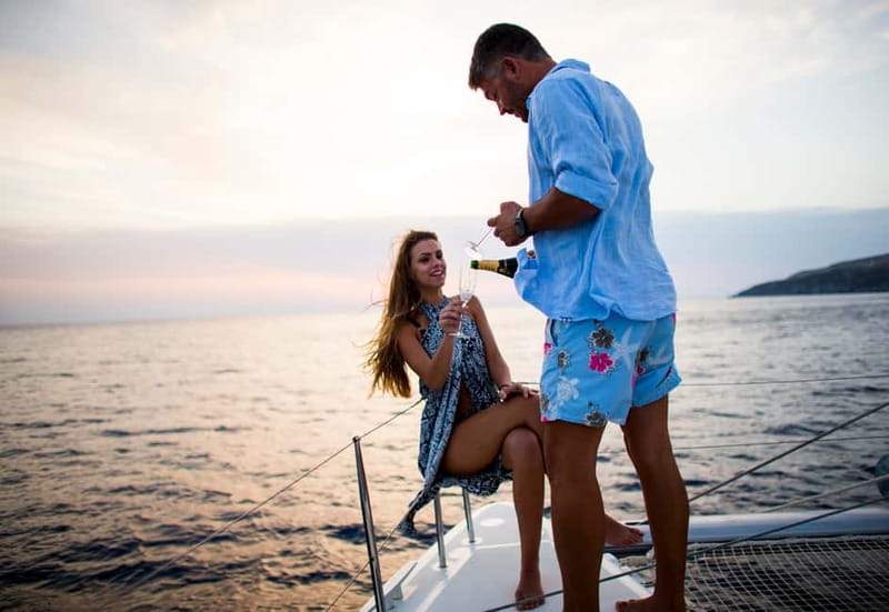Santorini: Private Catamaran Cruise with BBQ Meal and Drinks - Caves, cliffs, and Fira Old Port from the sea