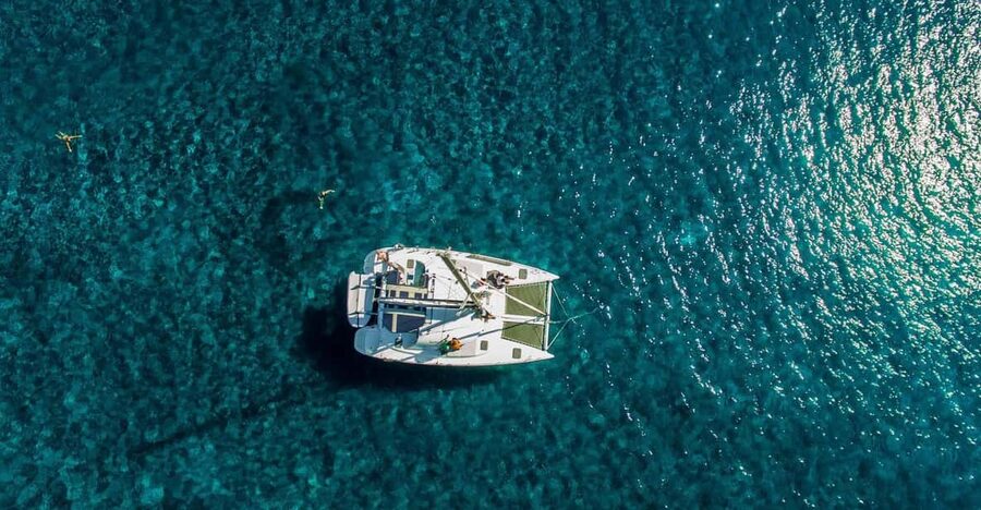 Santorini: Private Catamaran Cruise with Food & Drinks - Lighthouse, Indian Rock, and Aspronisi