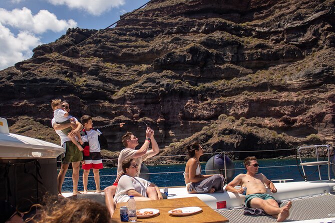 Santorini Sailing Catamaran Daily Cruises w/ Greek BBQ @Thirasia - The Akrotiri Lighthouse from the sea