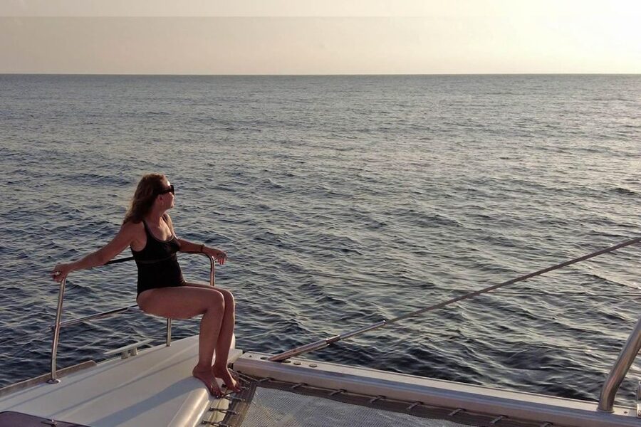 Santorini: Sunset Sailing Cruise, with Dinner and Drinks - Red Beach: dramatic rock and the first swim