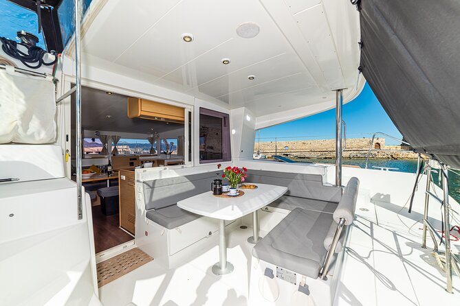 Small Group Santorini Catamaran Cruise with BBQ - Volcano Hot Springs: Warm Water And Dark Volcanic Shores