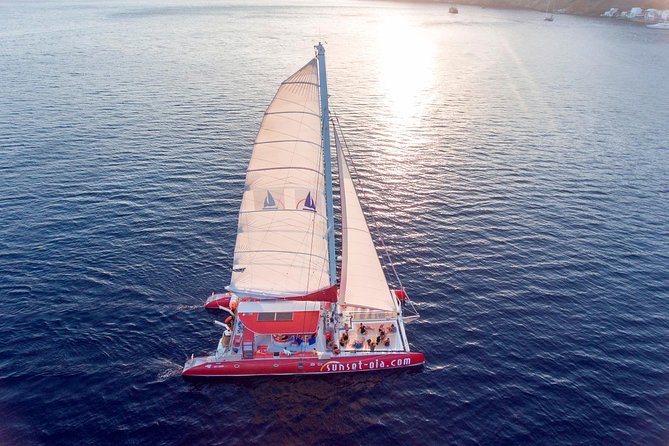 Sunset Sailing Catamaran Cruise in Santorini with BBQ and Drinks - Sunset near Oia, if the timing lines up